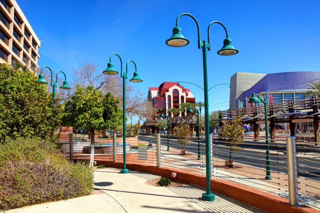 The Best Destinations for Autism Families in the US. Should we fly or drive? Read More. The accompanying photo shows a street lined with trees. A red building rises in the background, beside a purple-roofed stadium. The foreground is a concrete patio lined with a metal fence and studded with green lamposts.