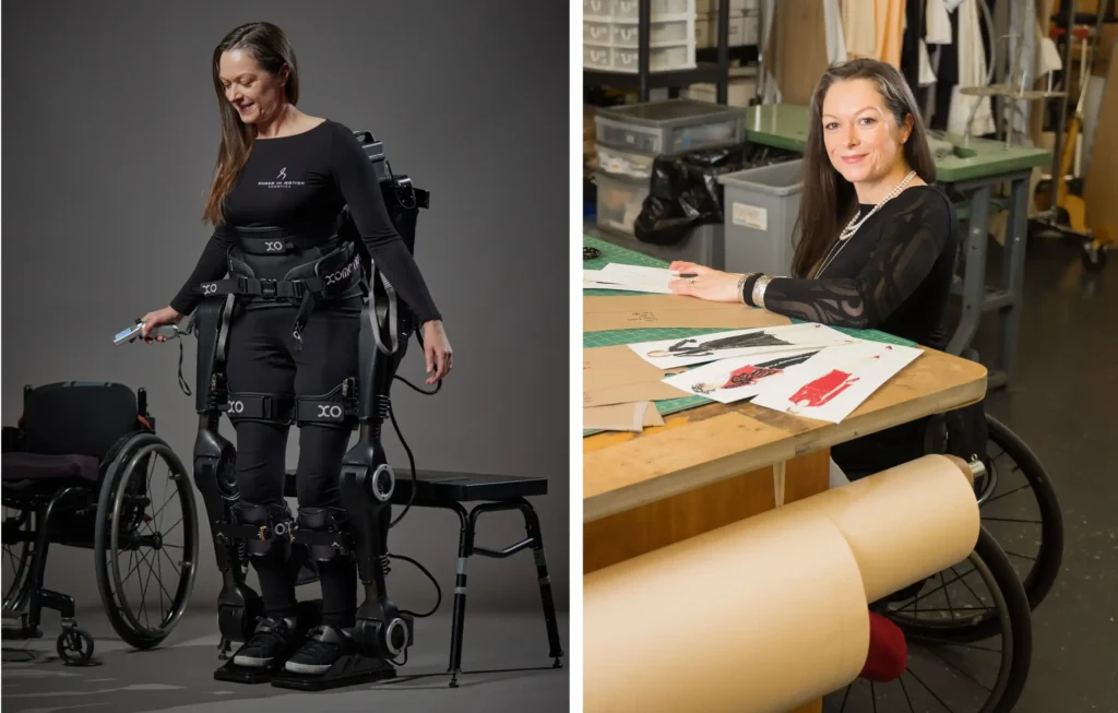 The image is a split view of a woman in two different scenarios. On the left, she is standing with the aid of a robotic exoskeleton, next to a wheelchair, suggesting she has limited mobility without the device. She is smiling and looking down at a device in her hand, possibly a control unit for the exoskeleton. On the right, the same woman is seated at a drafting table, appearing to be working on some designs or artwork, with a smile on her face. The contexts presented are likely intended to show the contrast between her life with assistive technology and her professional life as a designer or artist. The exoskeleton enables her to stand and potentially walk, highlighting advances in technology that improve the quality of life for people with disabilities.