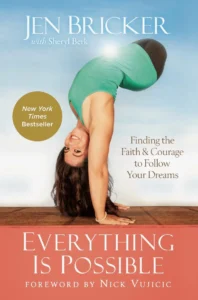 Book cover for Everything Is Possible by Jen Bricker with Sheryl Berk. The cover features Jen Bricker, an athlete born without legs, in a handstand with a bright smile. She wears a green tank top and black shorts. The background is a clear blue sky with a sunburst near her shoulder. A gold circle highlights the book's status as a New York Times Bestseller. The subtitle reads, 'Finding the Faith & Courage to Follow Your Dreams,' with a foreword by Nick Vujicic