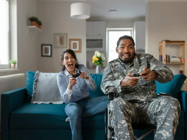 gaming A man and woman in military uniforms engaged in a friendly video game competition.