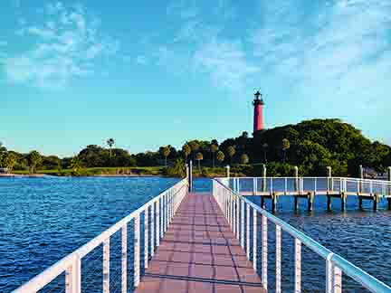 Scenic pier view of Jupiter Inlet Lighthouse in The Palm Beaches Florida vacation destination