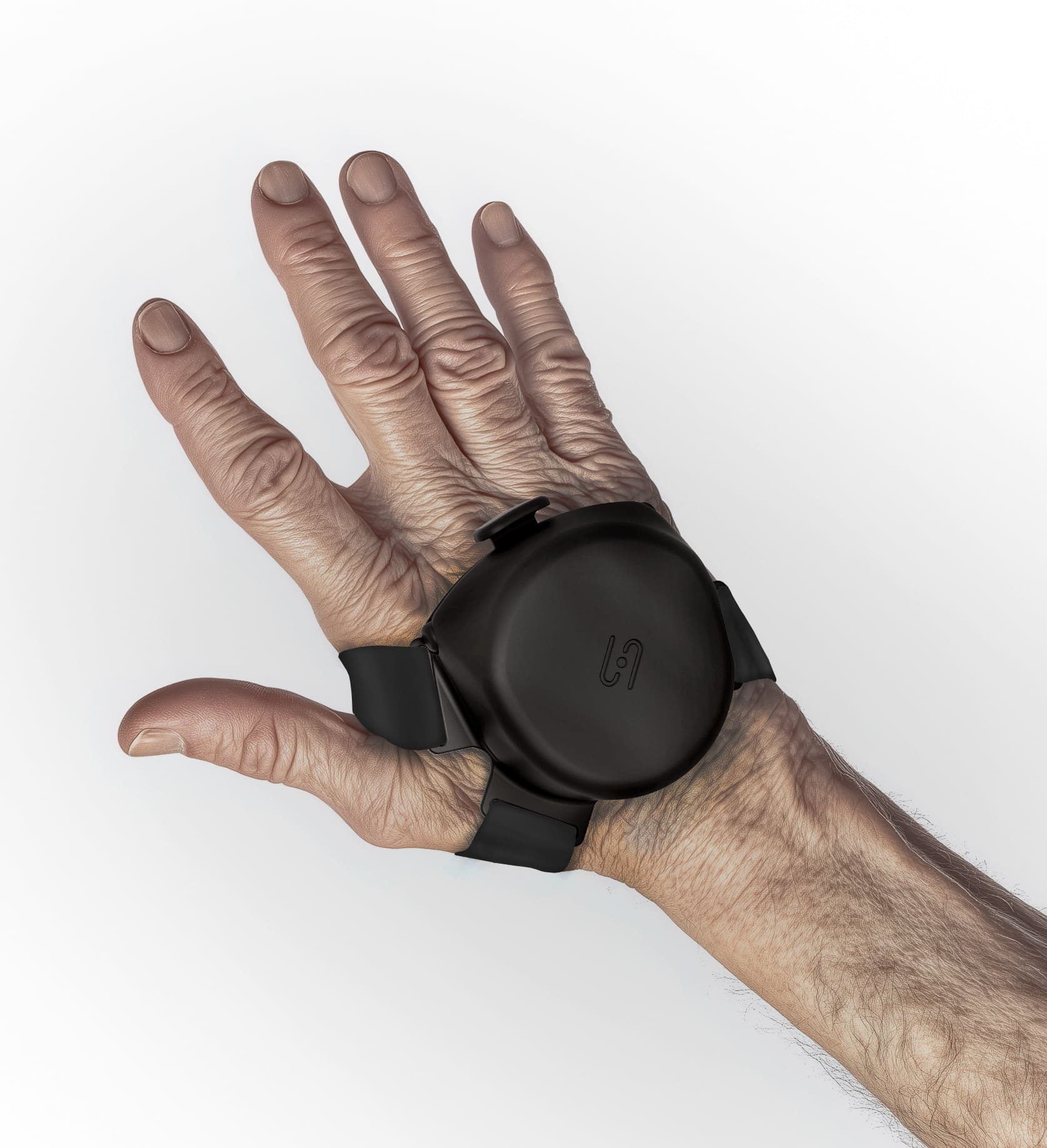 A stark, close-up studio shot of the Steadi-One anti-tremor wrist device (or similar model) being worn on the back of an elderly hand. The device is a compact, round, black unit secured with black straps. The hand is held against a clean, white background, emphasizing the fit and design of the assistive device.