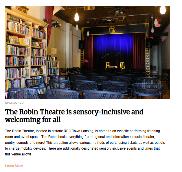 Interior view of the Robin Theatre in REO Town Lansing, showing rows of empty chairs facing a small stage with a blue curtain, highlighting the venue's commitment to sensory-inclusive events and charging outlets for mobility devices.