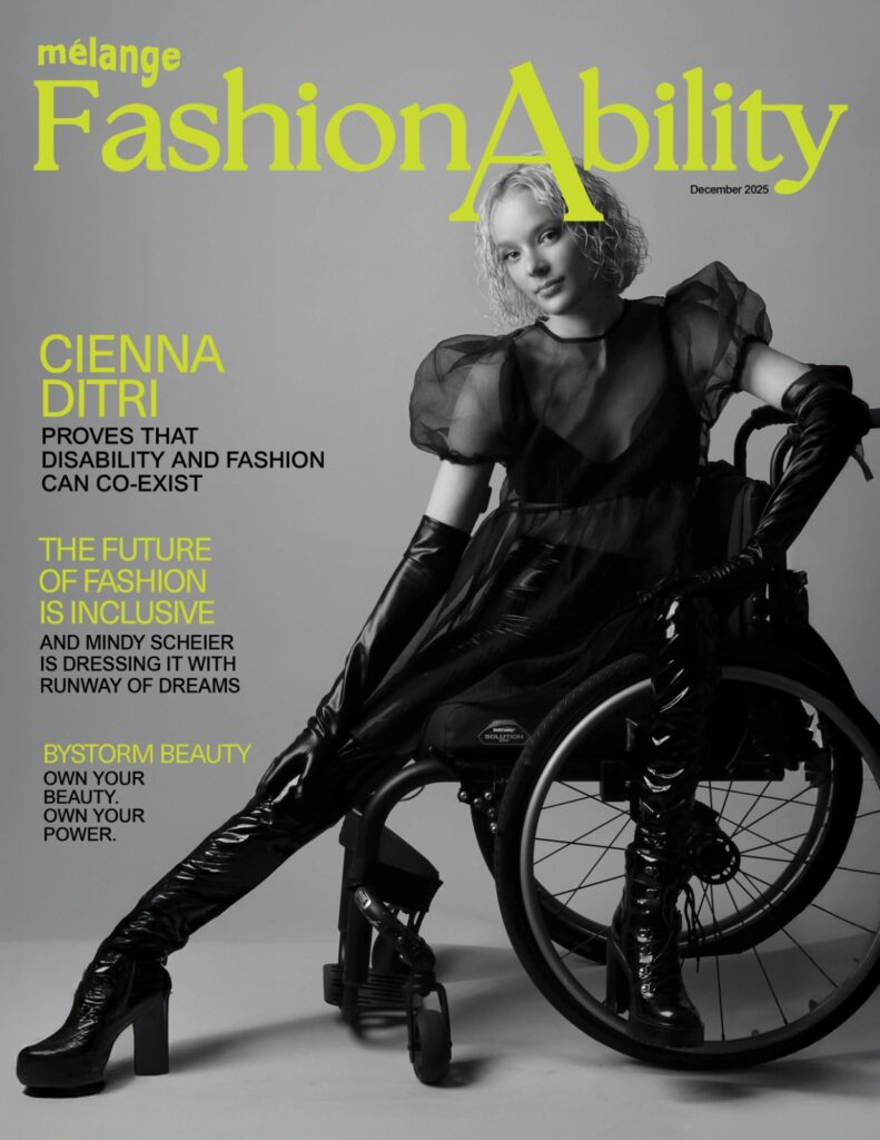 A black and white magazine cover for "mélange FashionAbility" dated December 2025. The cover features model Cienna Ditri, a young woman with short, blonde, wavy hair, sitting in a wheelchair. She is wearing a high-fashion, all-black ensemble: a sheer top with puffed sleeves over a camisole, long leather-like opera gloves, and tight-fitting patent leather boots with high heels. She poses with one leg extended forward and a confident expression. The background is a neutral grey. The magazine title "FashionAbility" and various headlines are printed in a bold, vibrant lime green. Headlines include "CIENNA DITRI PROVES THAT DISABILITY AND FASHION CAN CO-EXIST" and "THE FUTURE OF FASHION IS INCLUSIVE."
