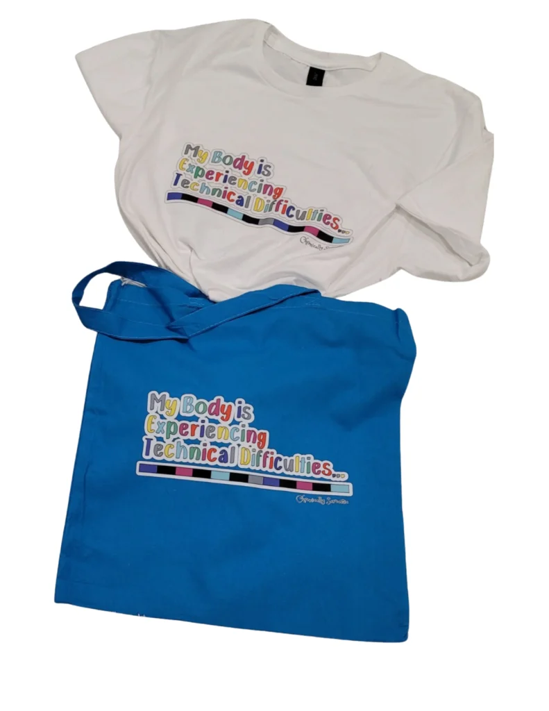 A white t-shirt and a bright blue tote bag laid out on a white surface. Both items feature the phrase "My Body is Experiencing Technical Difficulties..." in colorful, blocky letters above a multi-colored geometric bar. The "Chronically Sarcastic" brand signature is visible in small script at the bottom right of the designs.