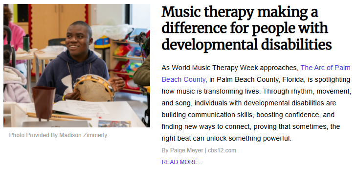 A smiling young man participating in a music therapy session with a tambourine at The Arc of Palm Beach County, Florida, for World Music Therapy Week.
