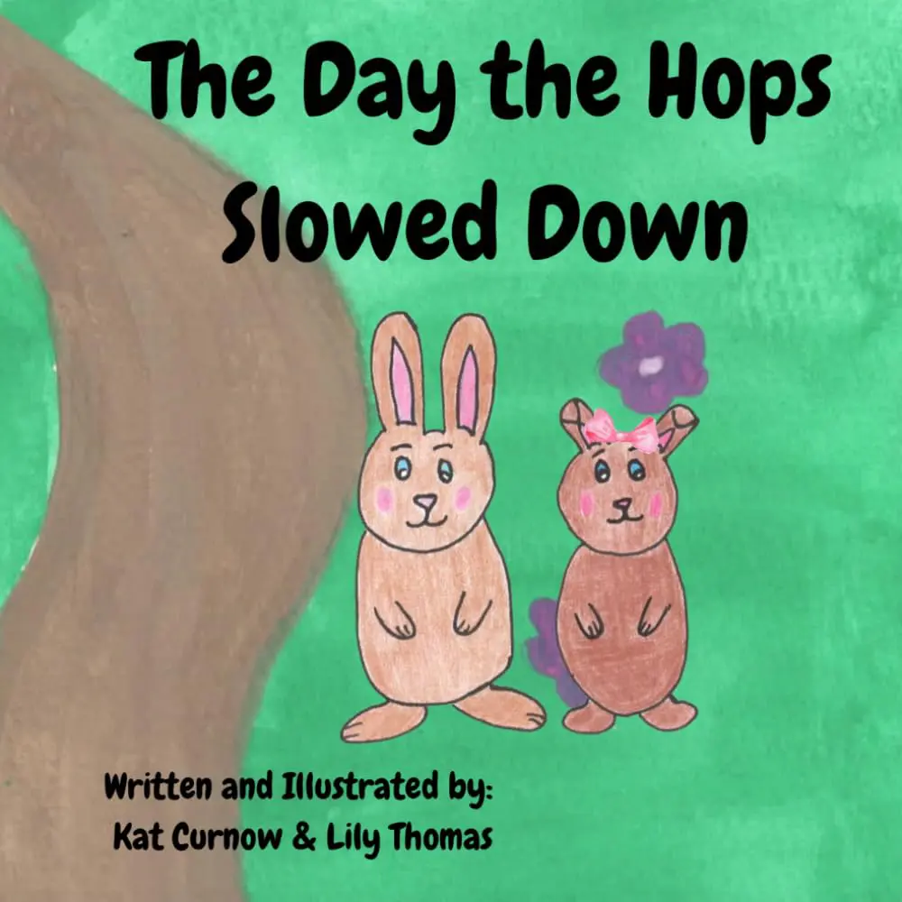 Illustrated children’s book cover titled The Day the Hops Slowed Down. The cover features two hand-drawn bunny characters standing on green grass beside a large tree trunk. One bunny wears a pink bow. Purple flowers appear in the background. Text at the bottom reads: “Written and Illustrated by: Kat Curnow