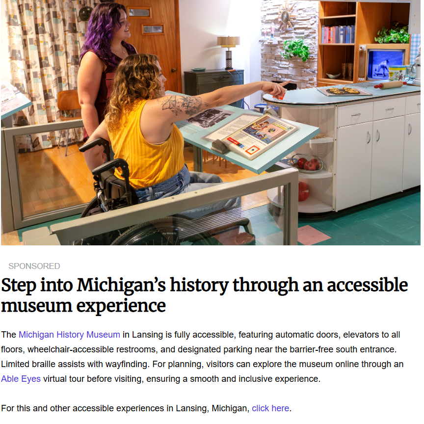 A woman using a wheelchair interacts with an accessible, tilted display exhibit inside the retro-themed Michigan History Museum while another woman stands nearby.