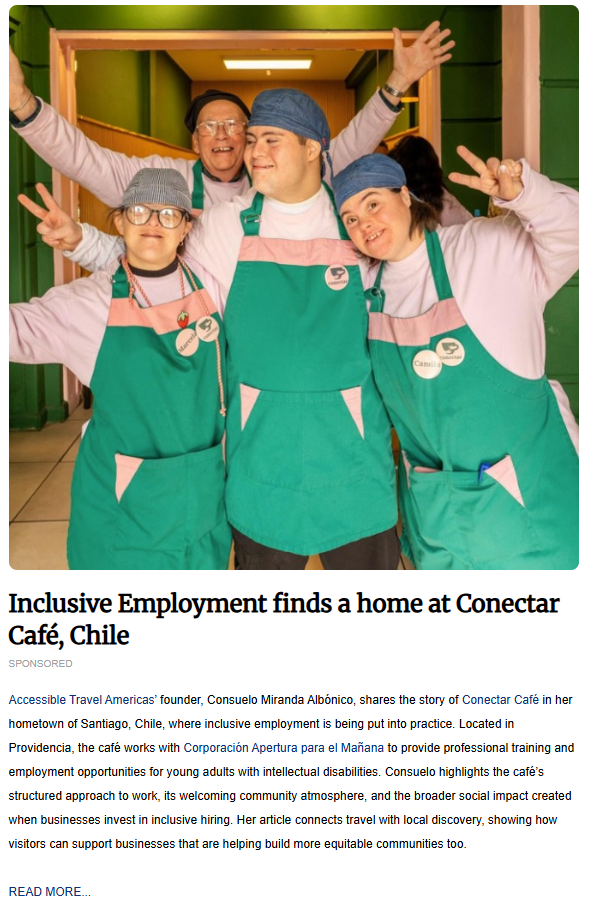 Group of café staff members smiling in green aprons, baker caps, and pink sweaters inside the café hallway.