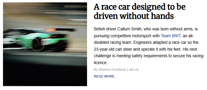 Motion-blurred shot of a green and black race car speeding along a racetrack.